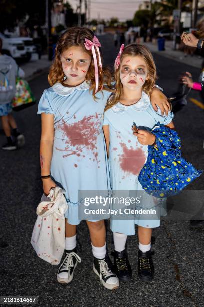 Young girls dressed as the twins from the film, "The Shining," one of the many Halloween costumes in a suburban neighborhood, on October 31, 2024 in...