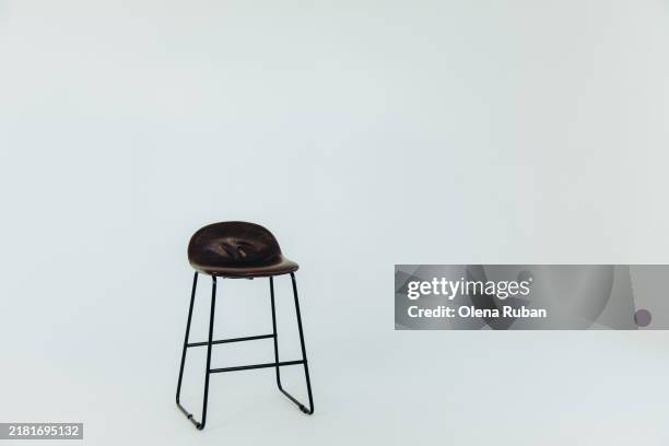 bar stool in a light setting. - taburete fotografías e imágenes de stock