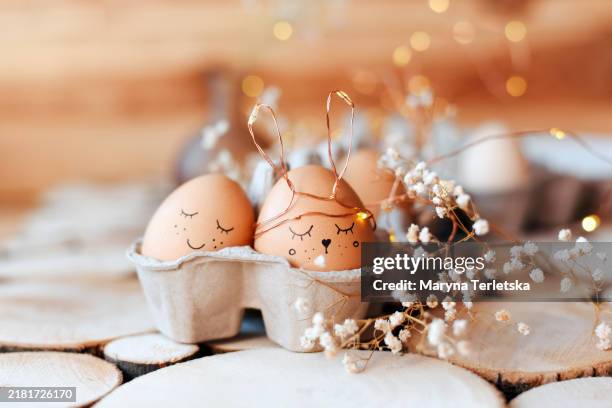 easter eggs with a smile. festive easter composition with eggs with cute faces painted on them. - painted easter eggs stock pictures, royalty-free photos & images