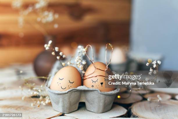 easter eggs with a smile. festive easter composition with eggs with cute faces painted on them. - easter egg food stock pictures, royalty-free photos & images