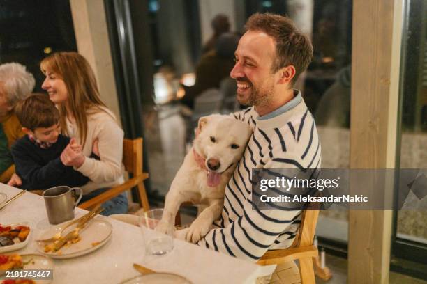 family celebrating thanksgiving at cabin house - hug christmas stock pictures, royalty-free photos & images