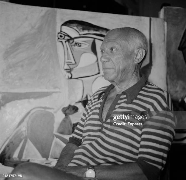 Artist and sculptor Pablo Picasso poses beside one of his artworks at his home, 'Villa La Californie', Cannes, France, September 30th 1955.