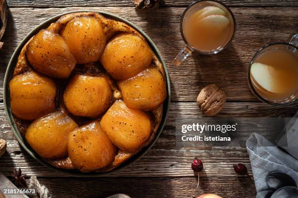 apple tarte tatin and warm apple cider, autumnal dessert - tarte tatin stock-fotos und bilder