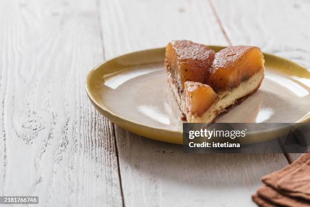 slice of apple tarte tatin, autumnal dessert - tarte tatin stock-fotos und bilder