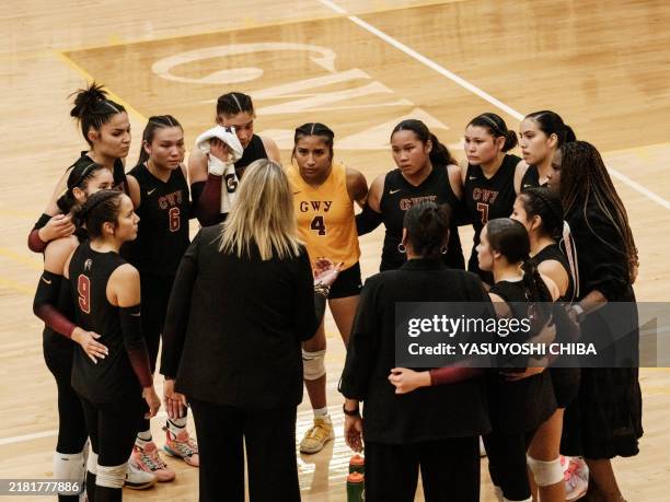 Chrokee High School volleyball players listen to their coach during the 1A West Regional Championship final match against Polk County High School at...