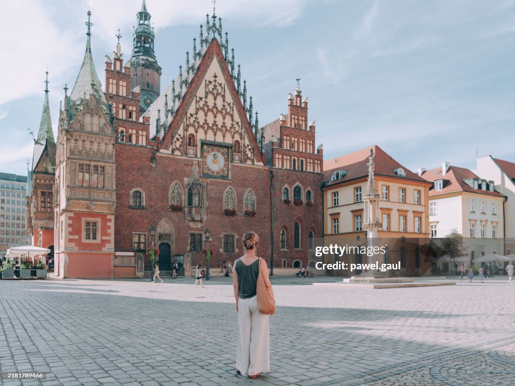 Woman in front of Old Town hall in Wroclaw city, Poland