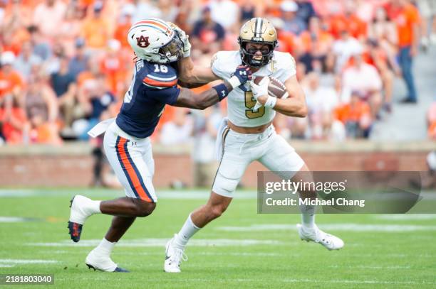 Wide receiver Richie Hoskins of the Vanderbilt Commodores looks to escape a tackle by safety Kaleb Harris of the Auburn Tigers during the first half...