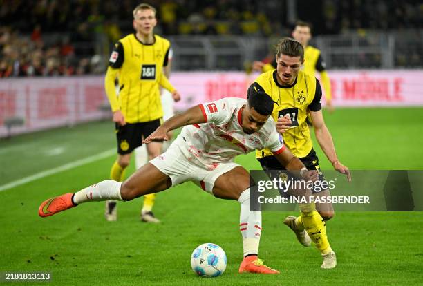 Leipzig's German defender Benjamin Henrichs and Dortmund's Austrian midfielder Marcel Sabitzer vie for the ball during the German first division...