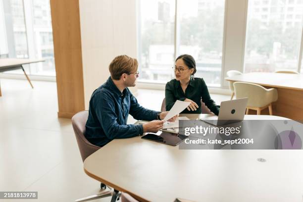 financial expertise shines through careful review of paper records - business finance and industry stock pictures, royalty-free photos & images