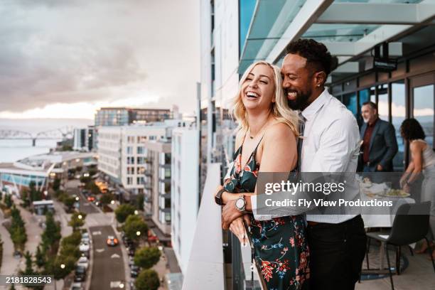 loving couple enjoying sunset views from restaurant rooftop terrace - hawaiian restaurant stock pictures, royalty-free photos & images