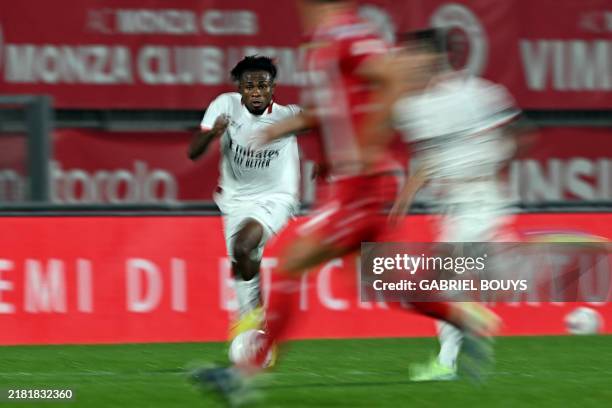 Milan's Nigerian midfielder Samuel Chukwueze runs with the ball during the Italian Serie A football match between AC Monza and AC Milan at the...