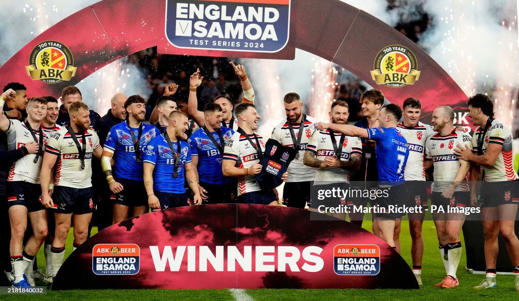 Amt Construction Rugby England's George Williams lifts the trophy after a series win against ...