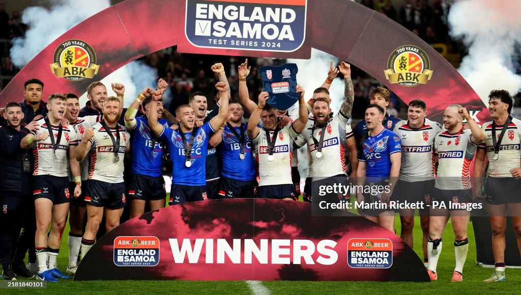 Amt Construction Rugby England's George Williams lifts the trophy after a series win against ...