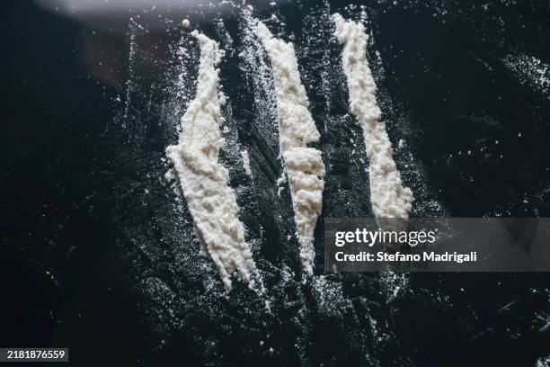 white powder on dark reflective surface - pure cocaine stock pictures, royalty-free photos & images