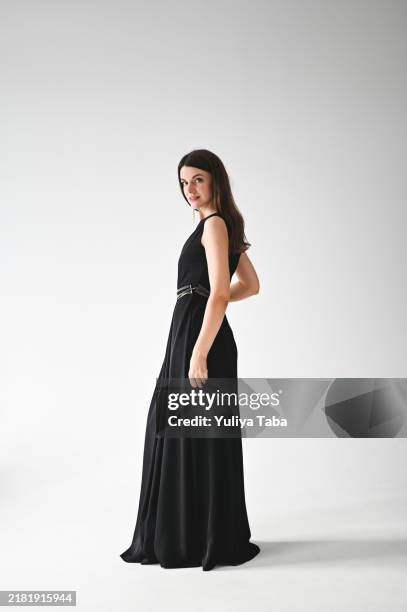 portrait of a young woman in a black dress. - glamorous female model photoshoot stock pictures, royalty-free photos & images