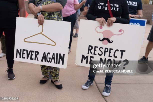 Reproductive rights supporters hold signs and share personal stories about reproductive care during the National Women's March at the Arizona State...