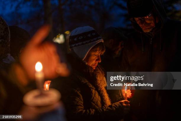 Mourners light candles and observe 399 seconds of silence for grizzly bear 399 at a memorial service on November 2, 2024 in Jackson Hole, Wyoming....