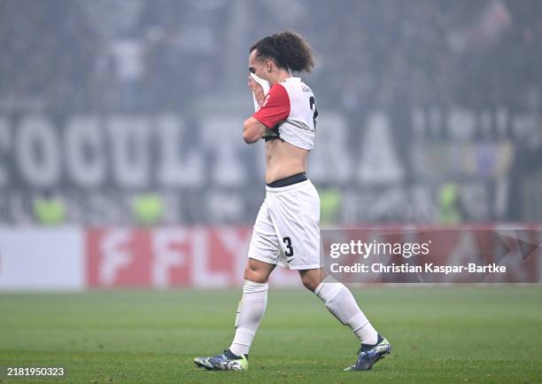 Arthur Theate of Eintracht Frankfurt leaves the pitch after receiving a red card during the DFB-Pokal match between Eintracht Frankfurt and Borussia...