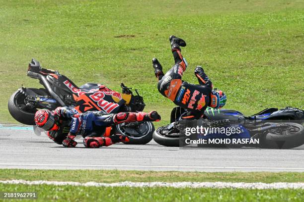 Monster Energy Yamaha MotoGP's French rider Fabio Quartararo and Red Bull KTM Factory's South African rider Brad Binder fall after a collision during...