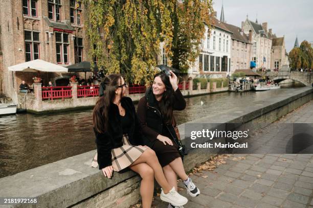 two tourist women in bruges, belgium - belgium stock pictures, royalty-free photos & images