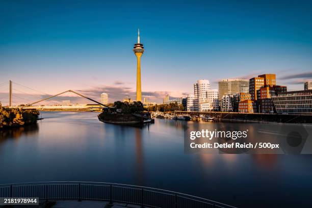 view of bridge over river in city - düsseldorf stockfoto's en -beelden