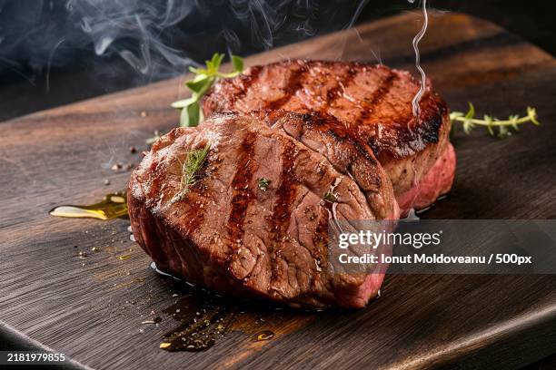 grilled beef steak on the dark wooden background - steak stock-fotos und bilder