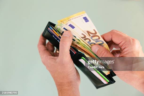 man taking money out of wallet - wallet stock pictures, royalty-free photos & images