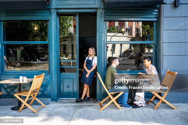 friends talking on a sidewalk cafe - restaurant outside stock pictures, royalty-free photos & images