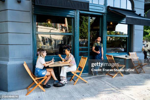 friends talking on a sidewalk cafe - restaurant outside stock pictures, royalty-free photos & images