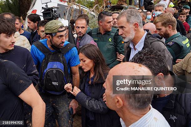 Queen Letizia and King Felipe VI of Spain react as angry residents heckle them during their visit to Paiporta, in the region of Valencia, eastern...