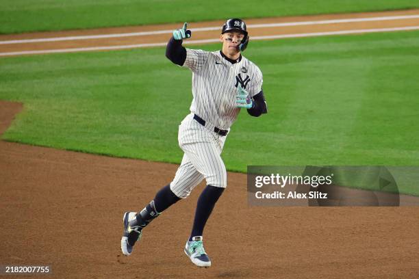 Aaron Judge of the New York Yankees rounds the bases after hitting a two-run home run during the first inning of Game Five of the 2024 World Series...