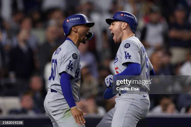 Freddie Freeman and Mookie Betts of the Los Angeles Dodgers celebrate after both scored on a two-RBI double by Teoscar Hernández during the fifth...