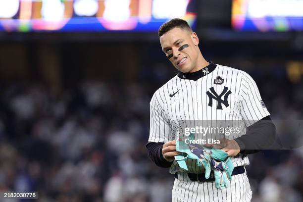 Aaron Judge of the New York Yankees walks off the field after being left on base during the eighth inning of Game Five of the 2024 World Series...