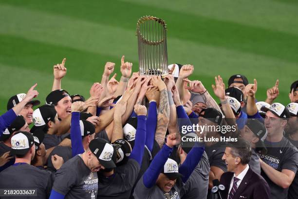 The Los Angeles Dodgers celebrate with the trophy after defeating the New York Yankees 7-6 in game 5 to win the 2024 World Series at Yankee Stadium...