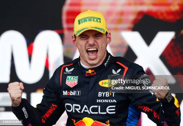 Red Bull Racing's Dutch driver Max Verstappen celebrates at the podium of the Formula One Sao Paulo Grand Prix, at the Jose Carlos Pace racetrack,...