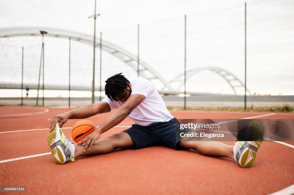 Young confused african basketball player practicing outdoor. Fit afro man in motion and movement. athletic and sport lifestyle