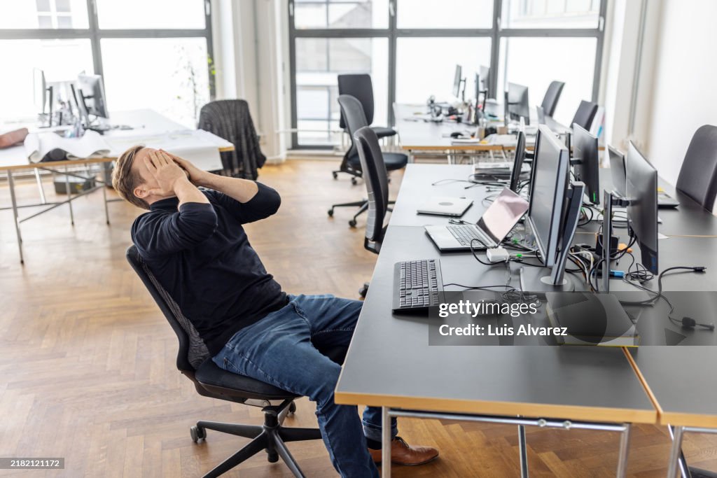 Office worker depressed and frustrated during computer work