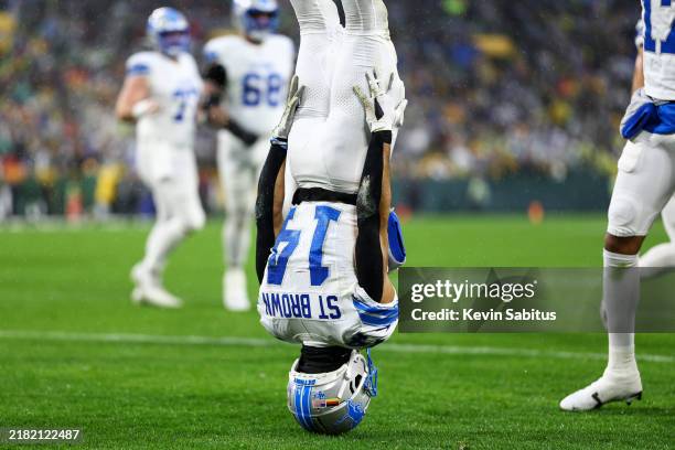 Amon-Ra St. Brown of the Detroit Lions celebrates after scoring a touchdown during the first half of an NFL football game against the Green Bay...