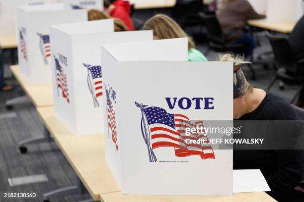 People cast their ballots on the last day of early voting for the general election in Michigan at the Livingston Educational Service Agency in...