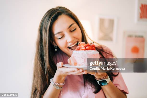 woman eating a cake. - over-eating stock pictures, royalty-free photos & images