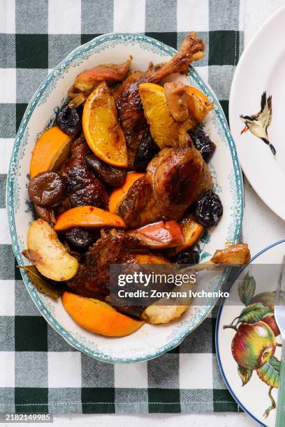 duck legs stewed with oranges, apples and dried fruits - dried plum stock pictures, royalty-free photos & images