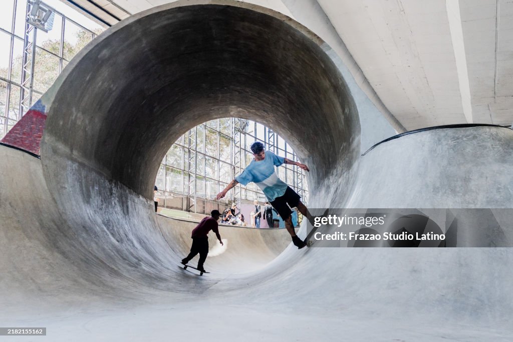 Skaters skating on a skateboard park