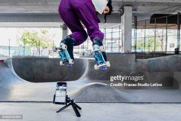skater filming herself on a skateboard park - visual tricks stock pictures, royalty-free photos & images