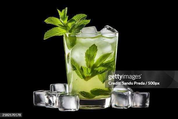 a high-quality photo of a mojito cocktail with a sprig of mint and ice - mojito stock pictures, royalty-free photos & images
