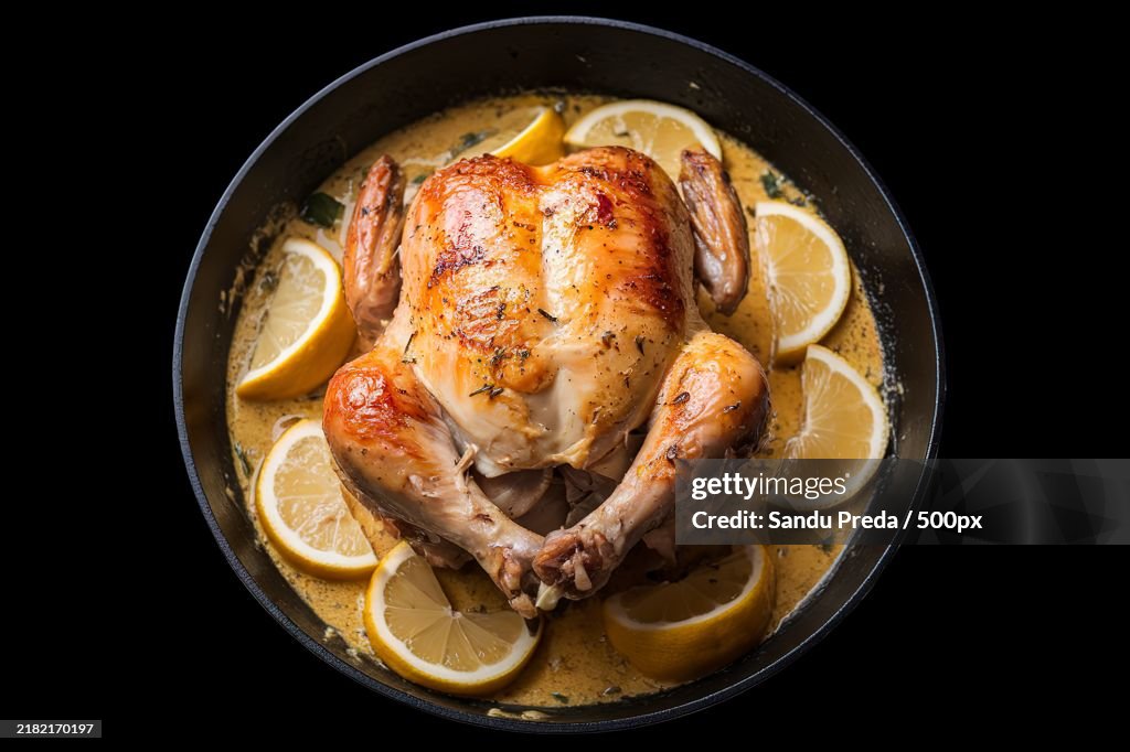 An image of a skillet containing a roasted chicken