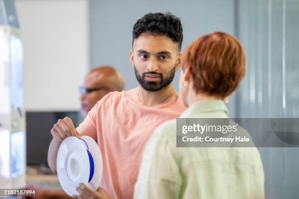 college student is learning to use a 3d printer in a makerspace lab - pakistani people stock pictures, royalty-free photos & images