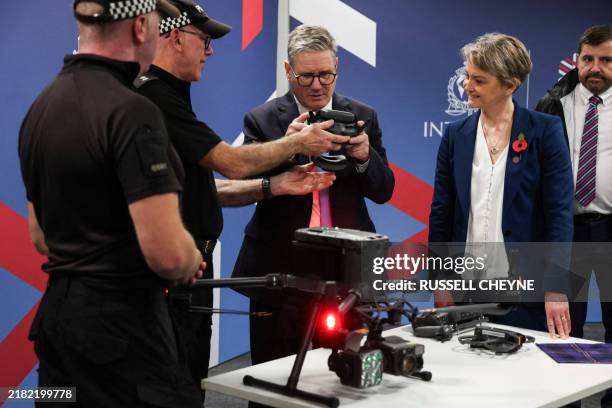 Britain's Prime Minister Keir Starmer and Britain's Home Secretary Yvette Cooper meet members of law enforcement agencies on the first day of the...