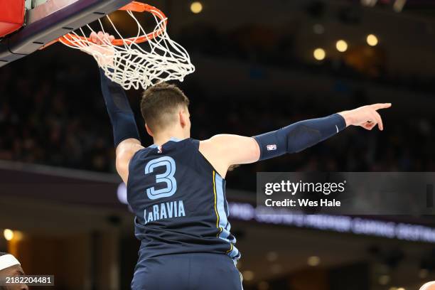 Jake LaRavia of the Memphis Grizzlies points after dunking the ball against the Milwaukee Bucks during the second half at FedExForum on October 31,...