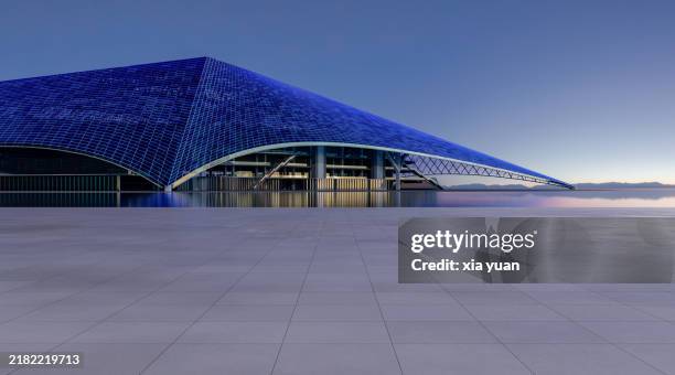 marble floor outside curvilinear structure architecture at sunset - zementboden stock-fotos und bilder