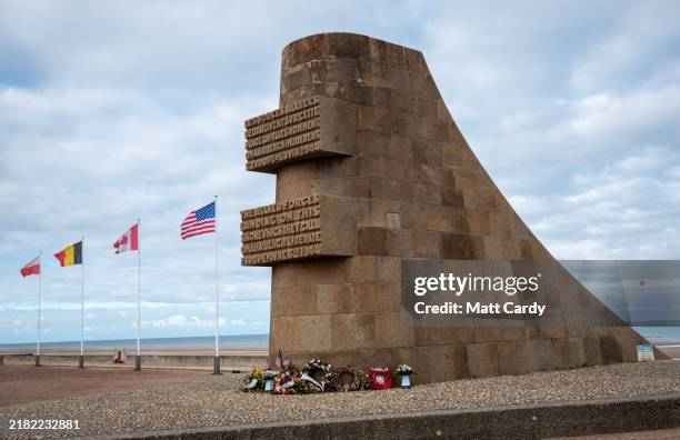 People pass a memorial on Omaha beach on October 30, 2024 in Colleville-sur-Mer, France. This year marked the 80th anniversary of the D-Day landings...